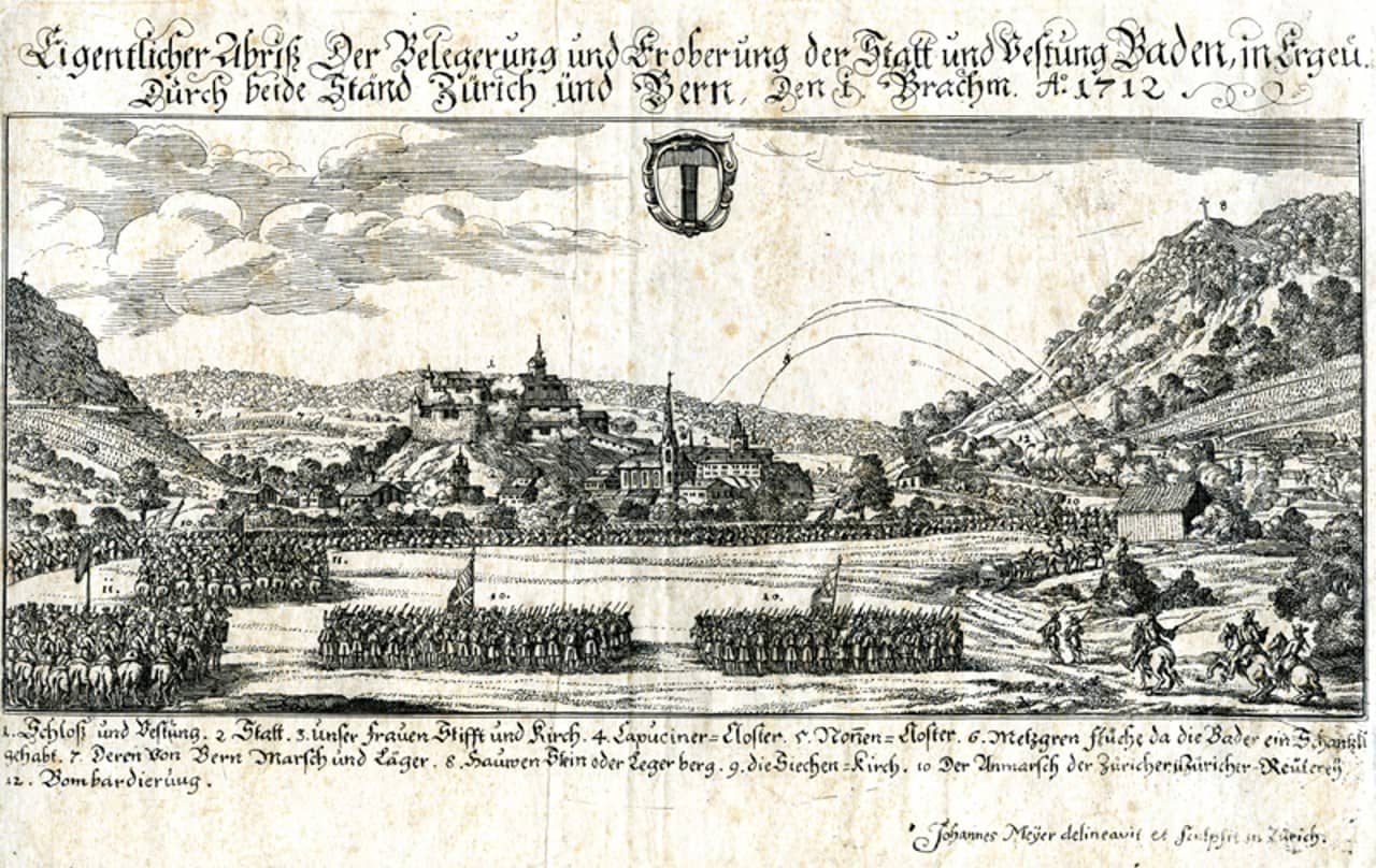 Kupferstich der Stadt Baden. Davor Truppen, die die Stadt belagern und Kanonenkugeln die von rechts auf die Stadt geschossen werden.