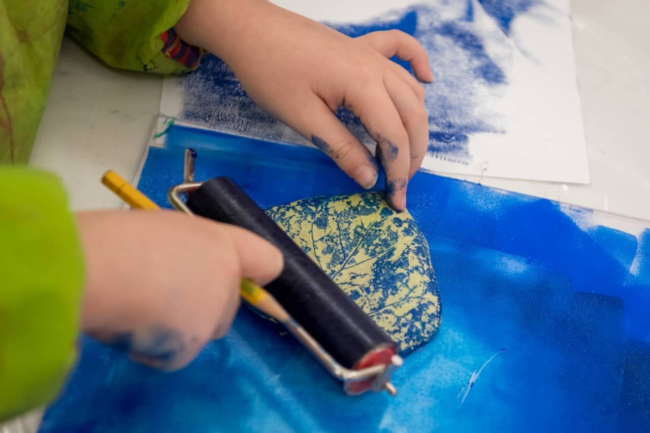 Eine Schülerin oder ein Schüler benutzt einen Rollstempel. 