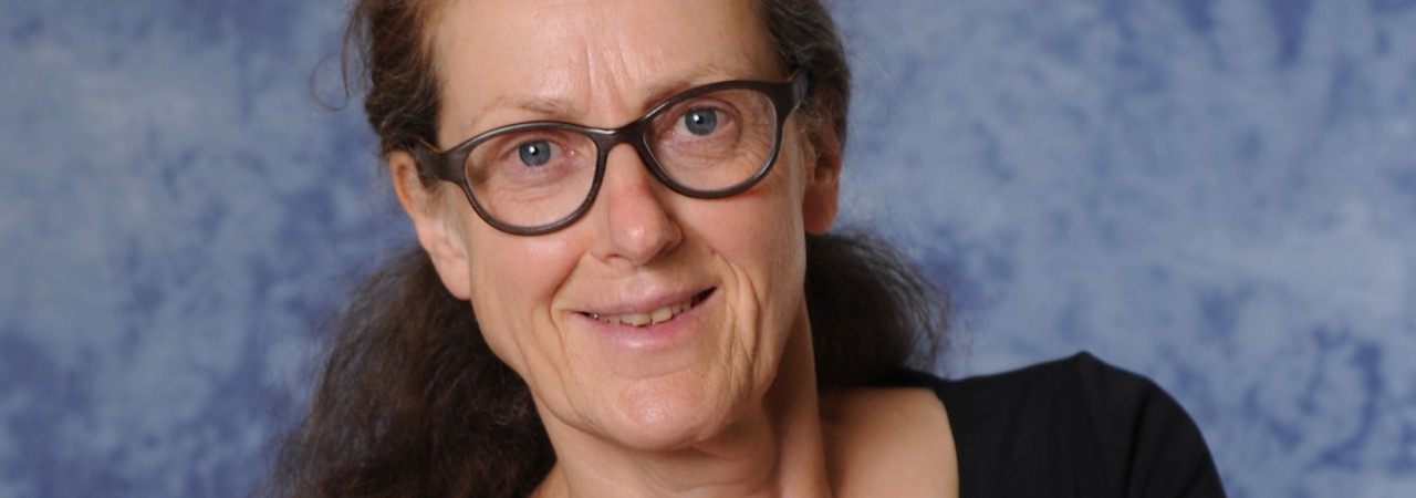 Frau mit Brille lächelt in die Kamera