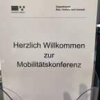 Aufnahme eines Schildes auf dem steht "Herzlich Willkommen zur Mobilitätskonferenz".