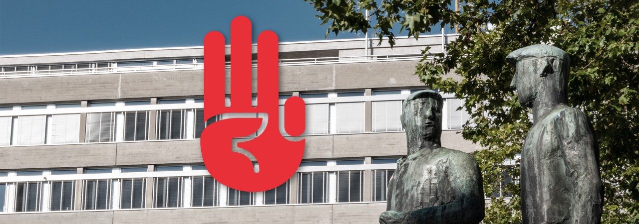 Bild einer Statue und einer Gebäudefassade am Zürcher Helvetiaplatz, das von einem roten Hand-Symbol überlagert wird.